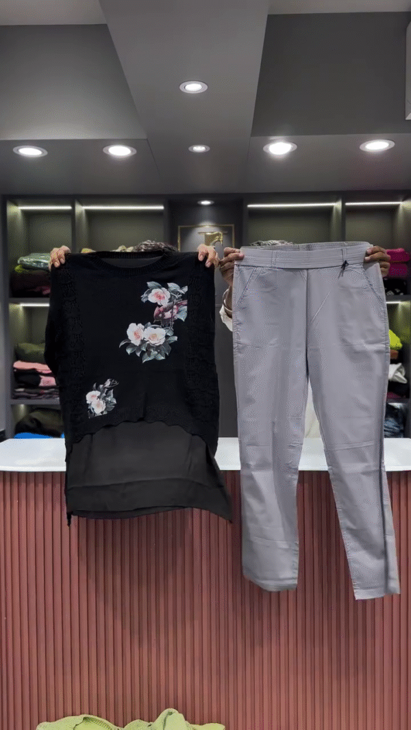 Black Open-Knit Top with Floral Appliqués and Gray Pants